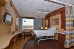 Room amenities contribute to a hotel atmosphere, including sleeper sofas and private bathrooms, and warm and inviting décor at Englewood Hospital and Medical Center.